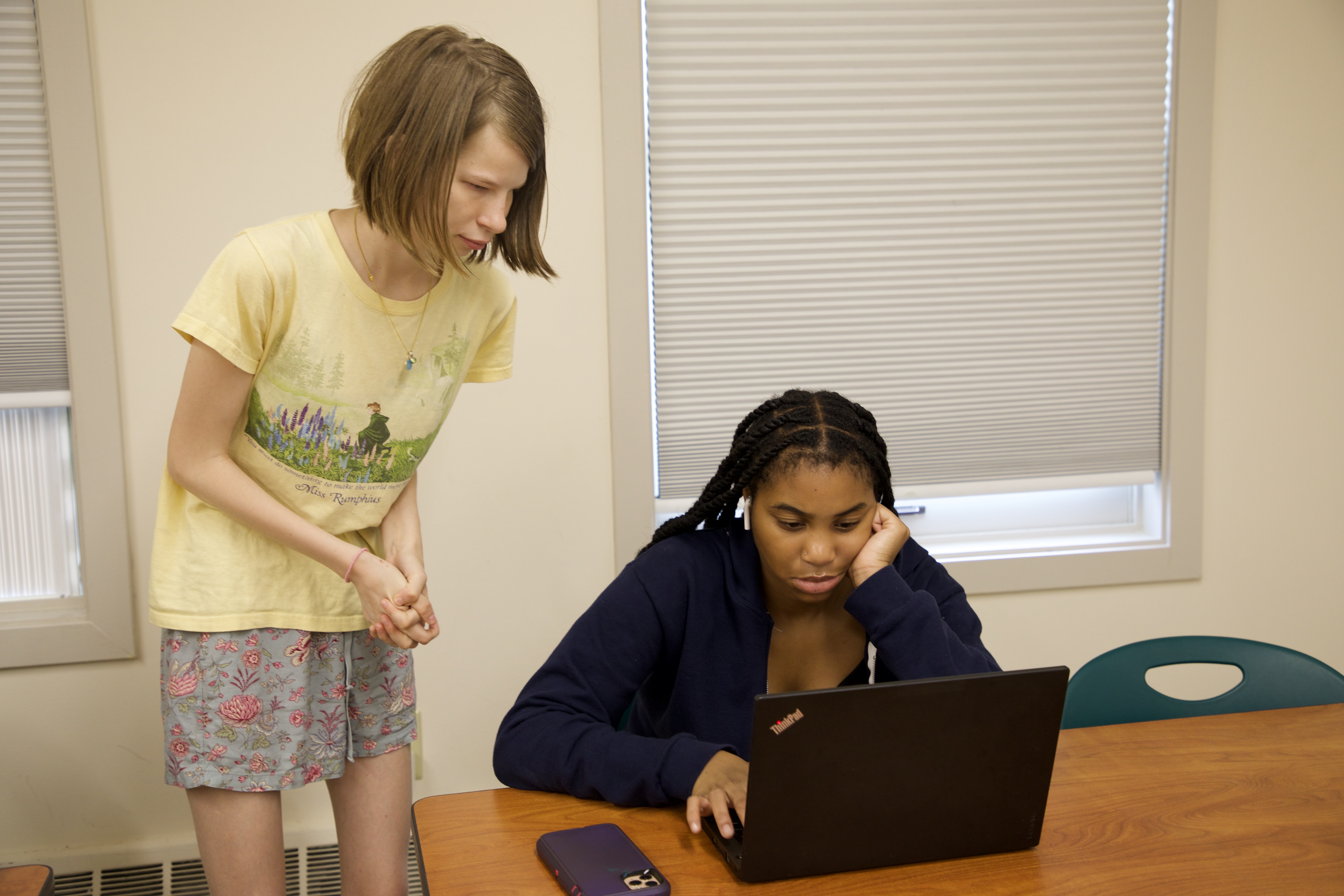 Teacher looks at student's computer