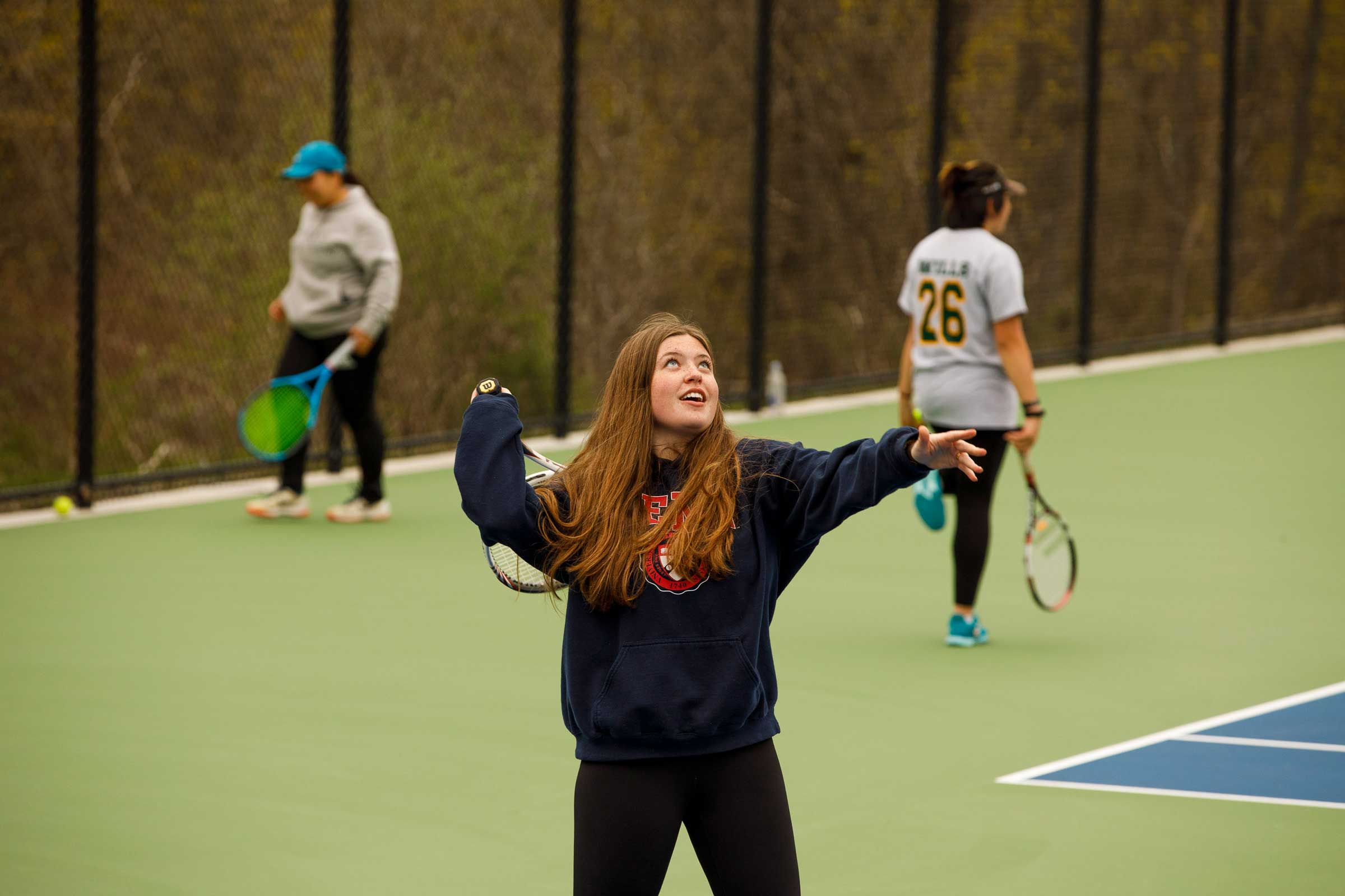 A student practices on tennis courts at Forman.
