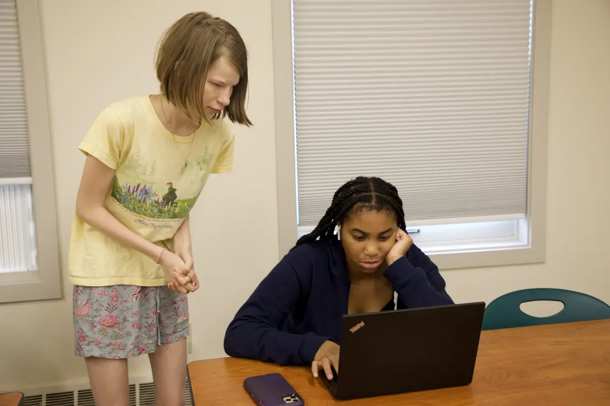 Teacher looks at student's computer